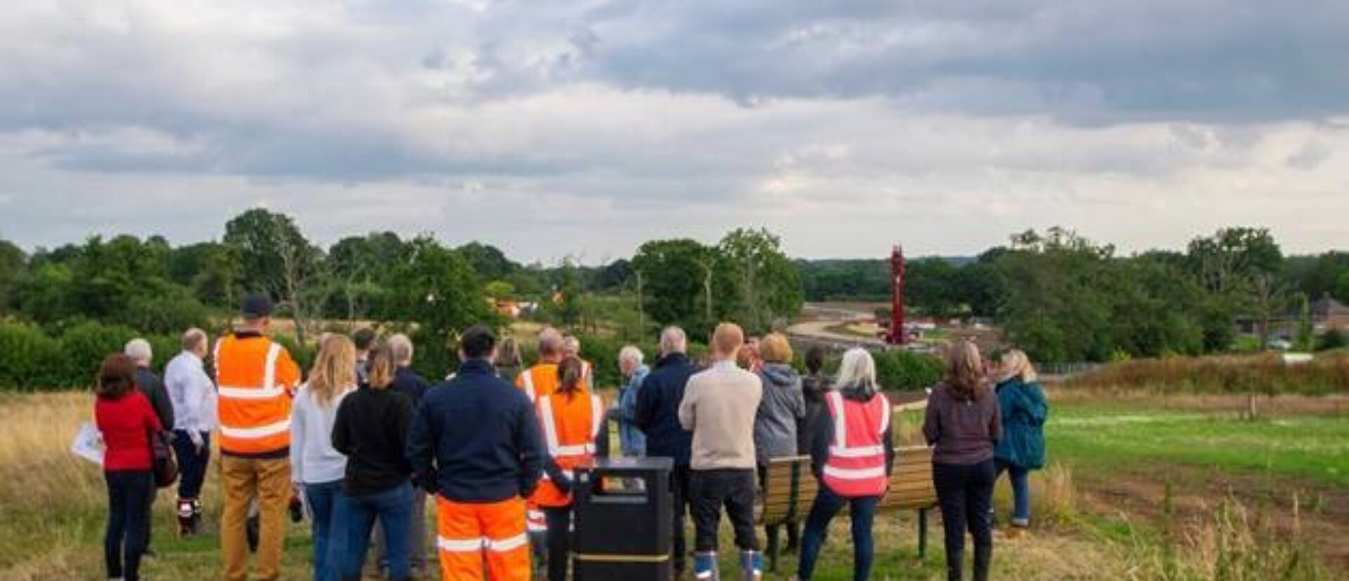 Councillors stood, back to the camera in the building field
