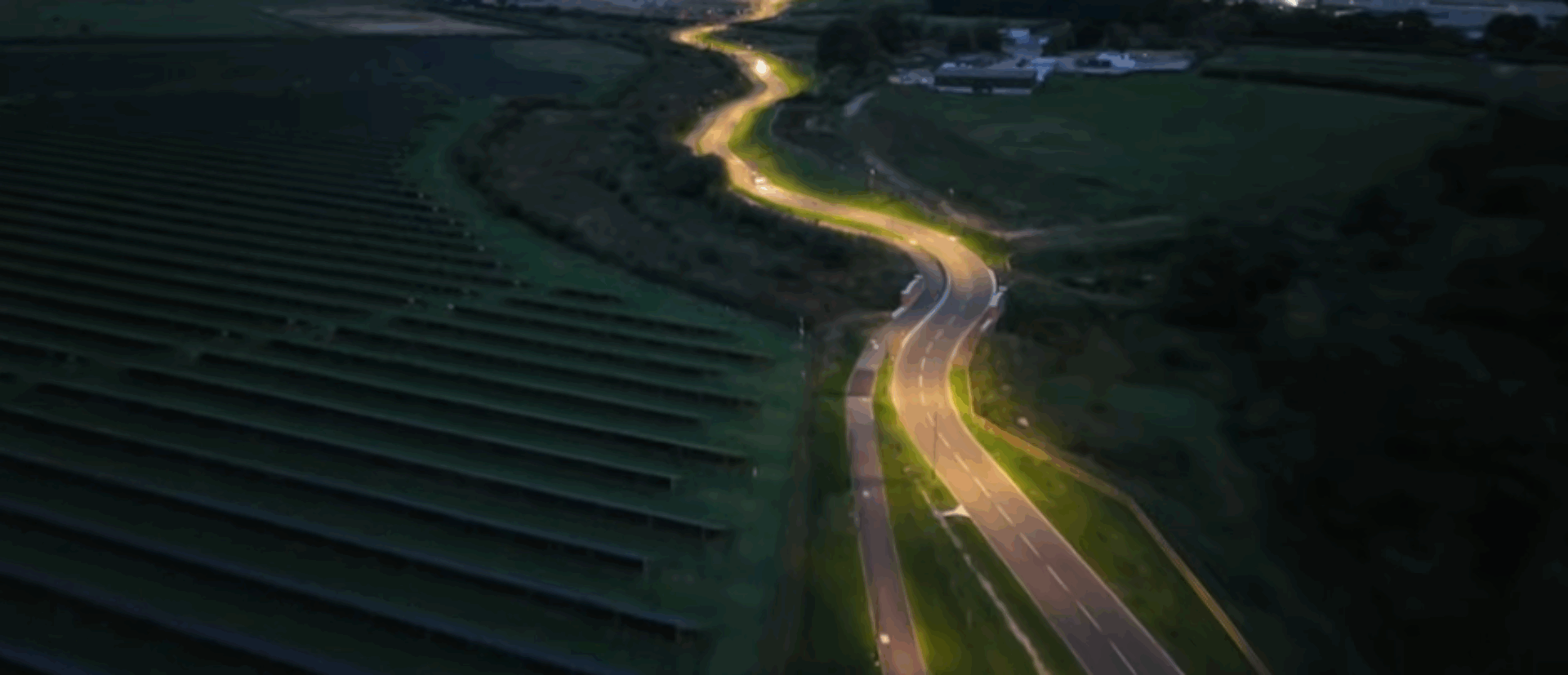 aerial image of a bendy road with at night, with lighting