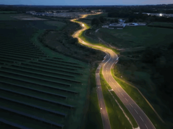aerial image of a bendy road with at night, with lighting