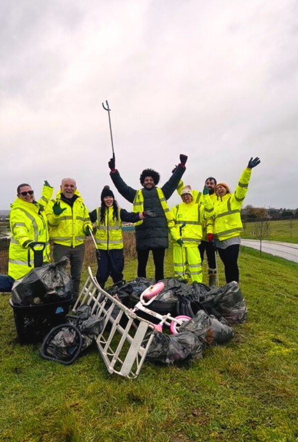 OHH and Wates team of litter pickers in high-vis walking