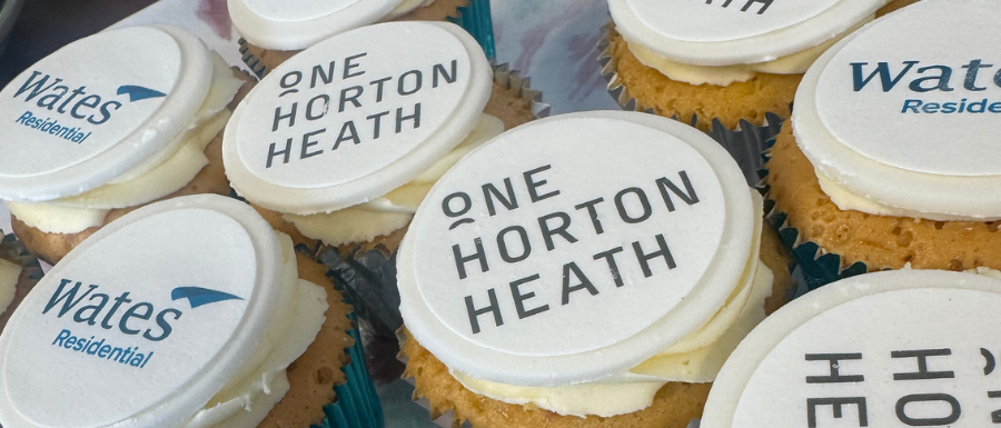 Banner - A plate of branded cupcakes that show OHH and Wates logos