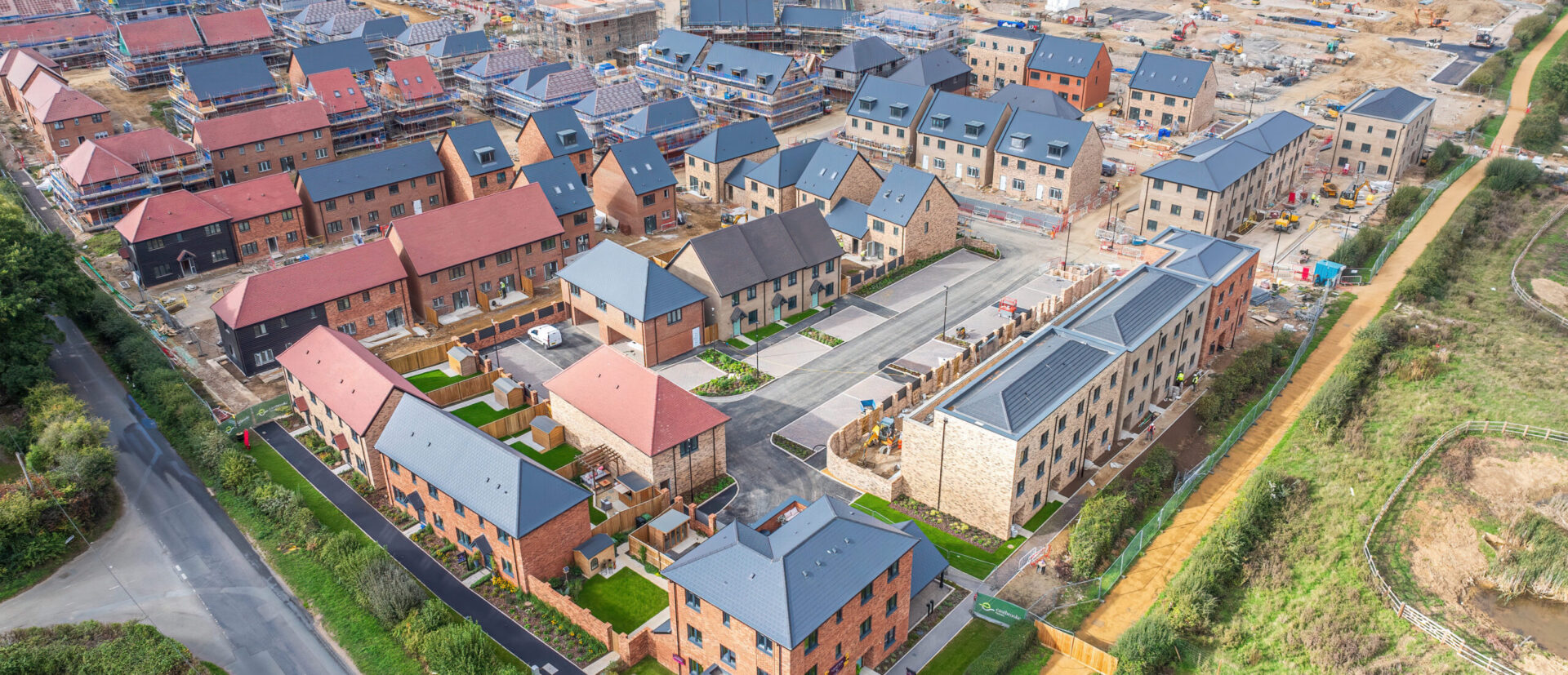 Ariel view of The Lower Acre, One Horton Heath showing a construction site and houses being built, with complete units