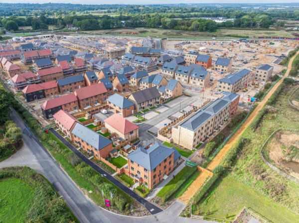 Ariel view of The Lower Acre, One Horton Heath showing a construction site and houses being built, with complete units